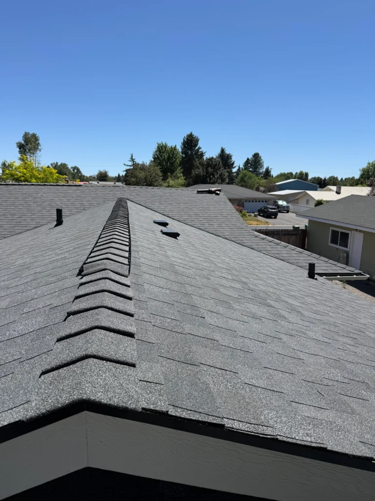 Finished gray shingle roof with a white gable edge