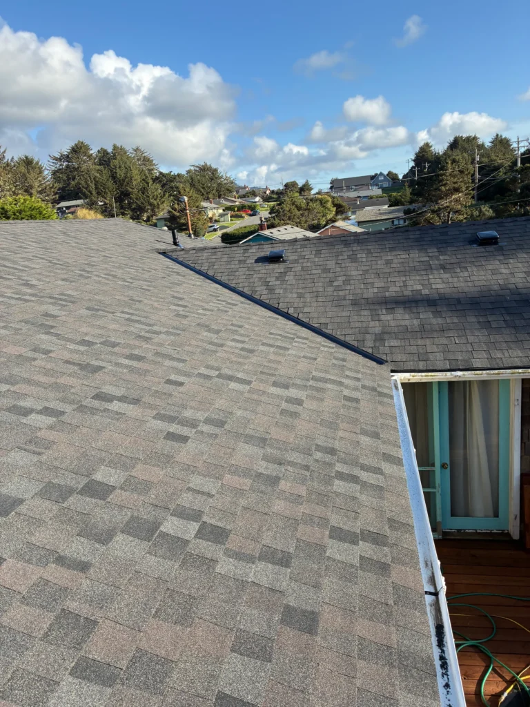 Residential shingle roof with a valley and adjoining eaves