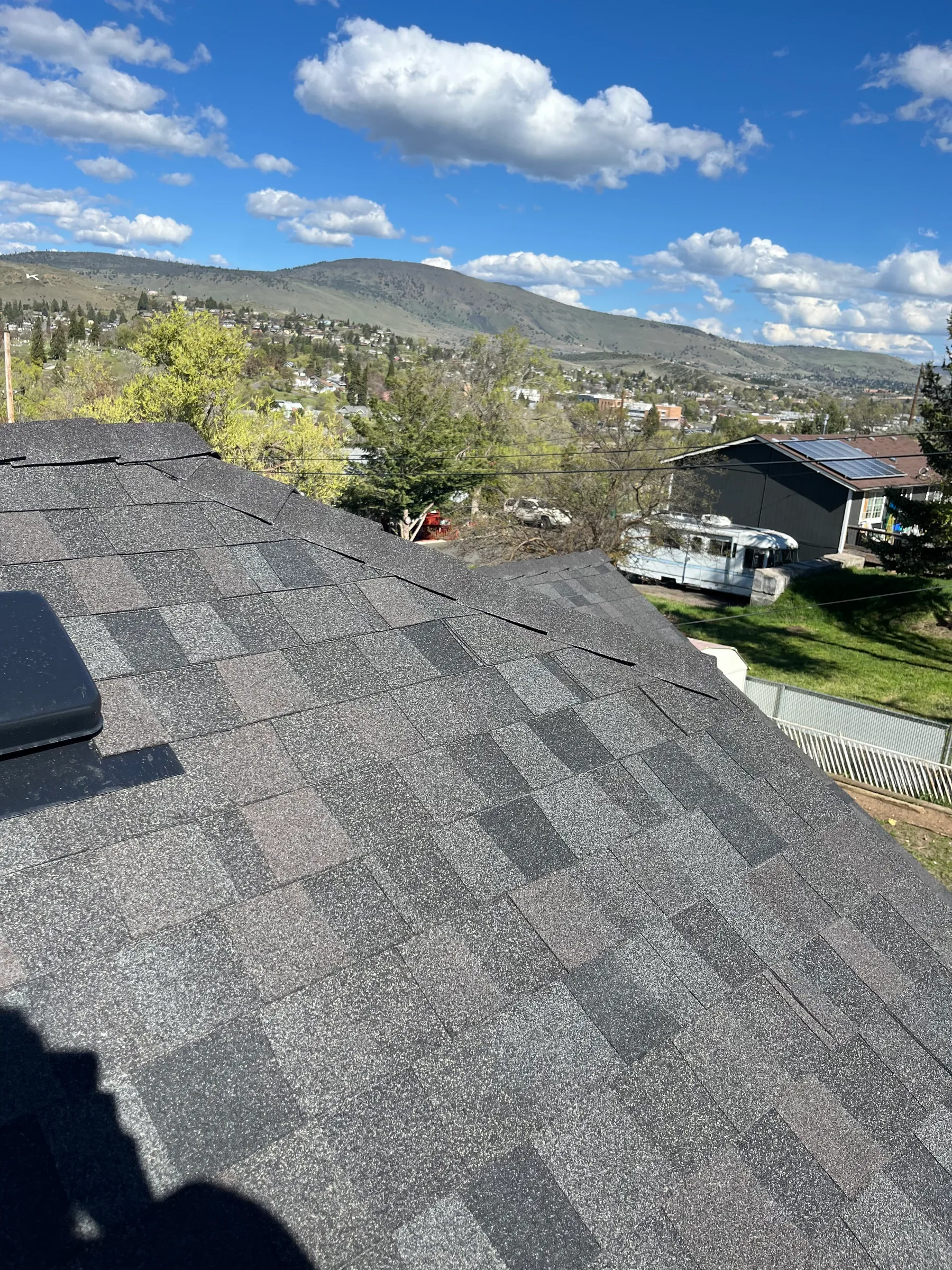 Shingle roof with a broad hillside and neighborhood outlook