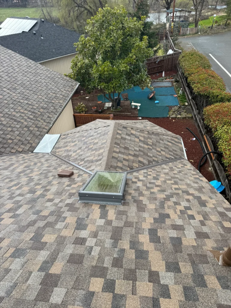 Skylight and flashing within an architectural shingle roof