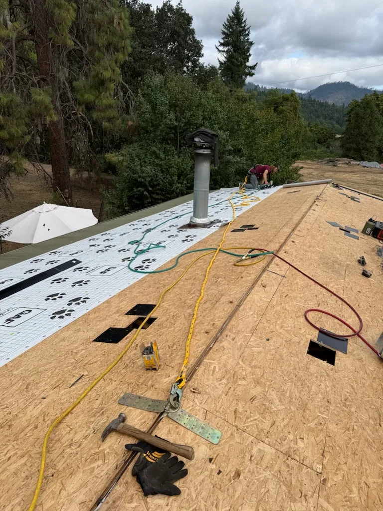 Roof sheathing and underlayment installation in progress