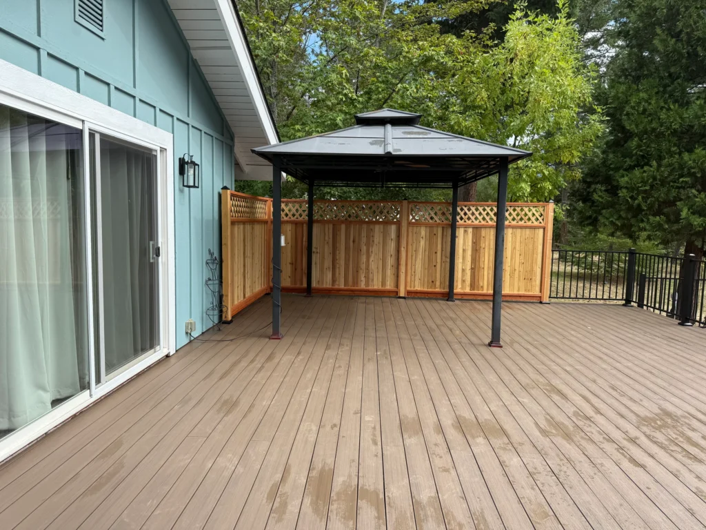 Residential deck with a gazebo and wood privacy screen
