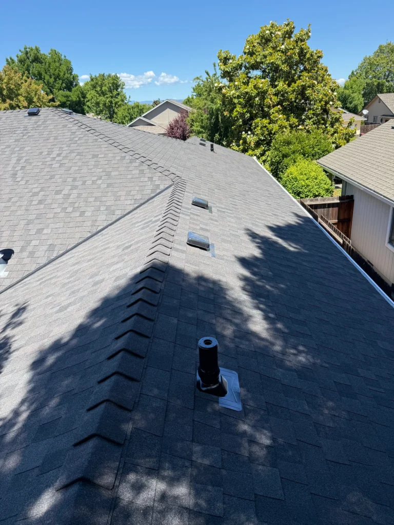 Finished shingle roof with ridge caps and roof vents